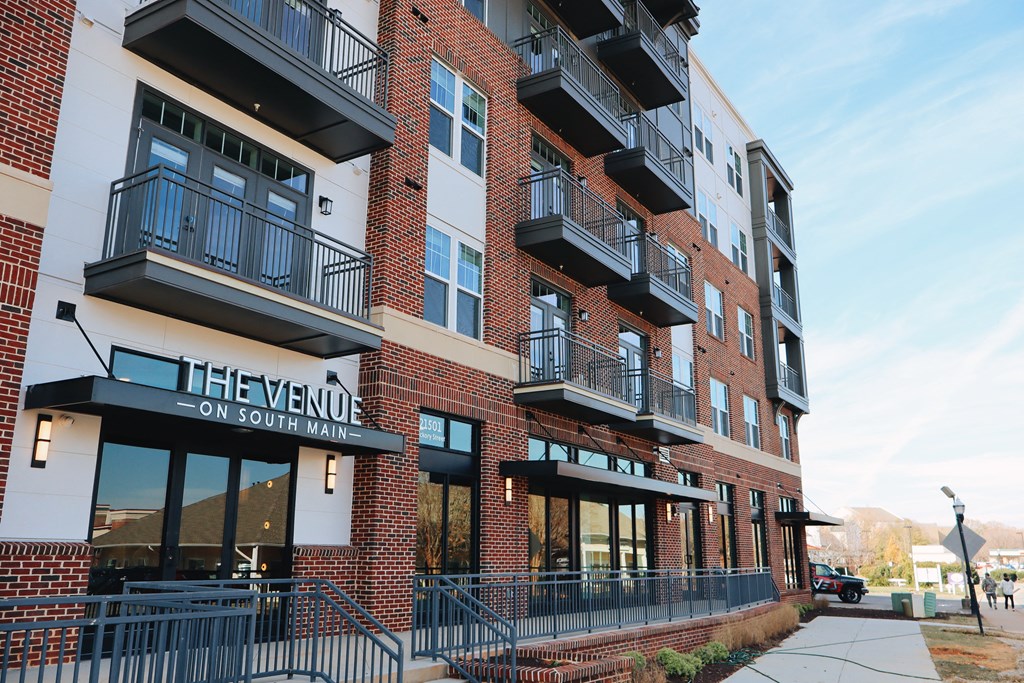 The Venue on South Main is a red brick building with black railings and balconies.