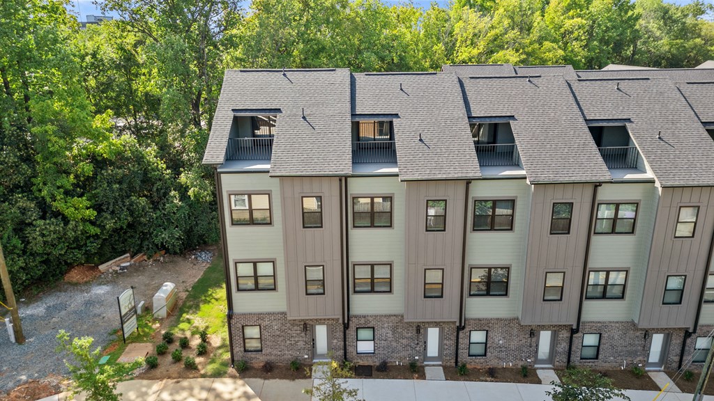 an aerial view of a building with a gray roof and trees at The Collection Charlotte in Charlotte, NC, 28205