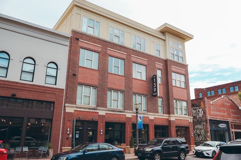 a large brick building with cars parked in front of it