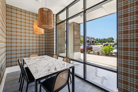 A dining room with a marble table and chairs.