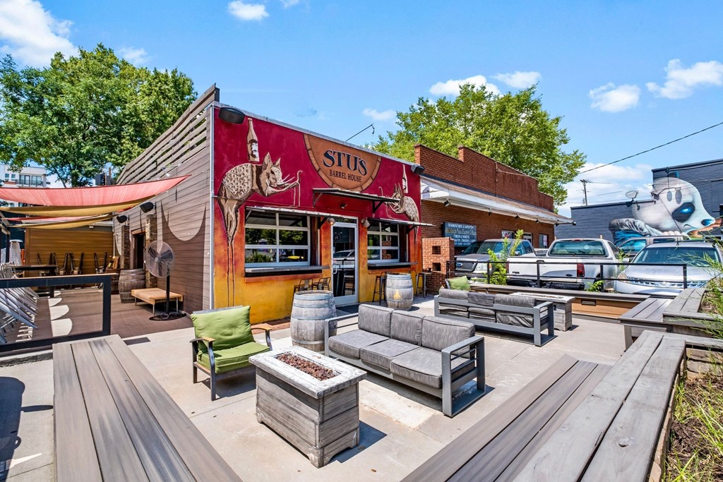 a patio with benches and tables outside of a restaurant at The Collection Charlotte in Charlotte, NC, 28205