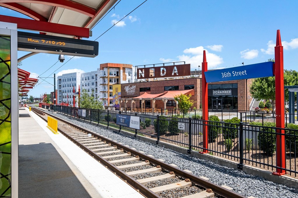 a train station with a city in the background at The Collection Charlotte in Charlotte, NC, 28205
