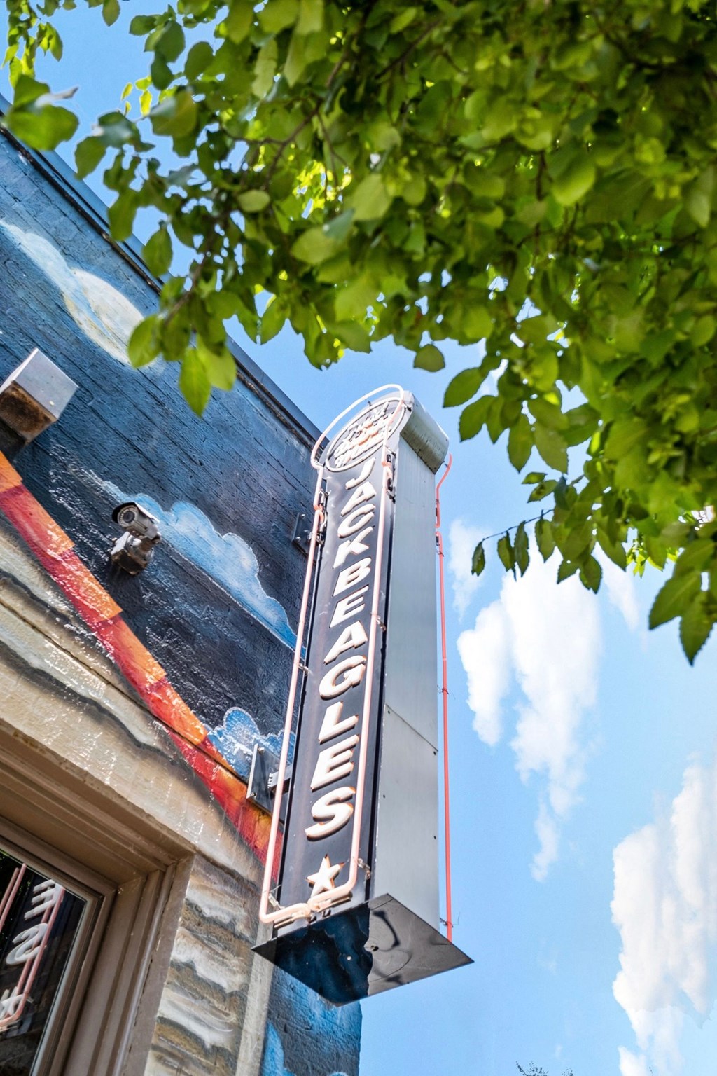 a neon sign on the side of a building at The Collection Charlotte in Charlotte, NC, 28205
