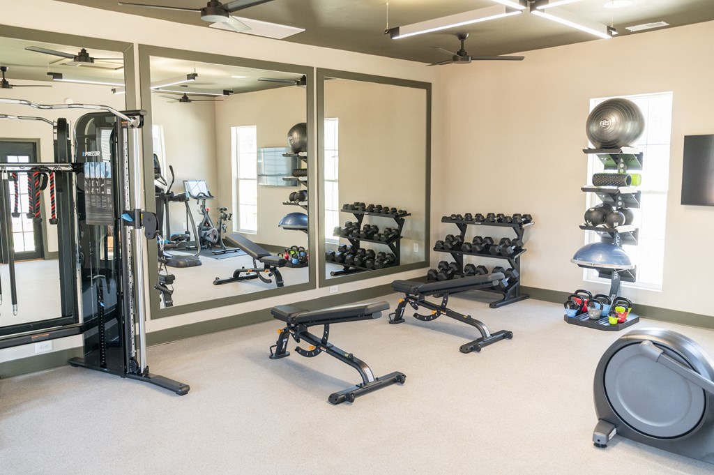 a fitness center with weights and other exercise equipment a fitness center with weights and other exercise equipment at Landon Green Artisan Cottages Apartments, Hickory