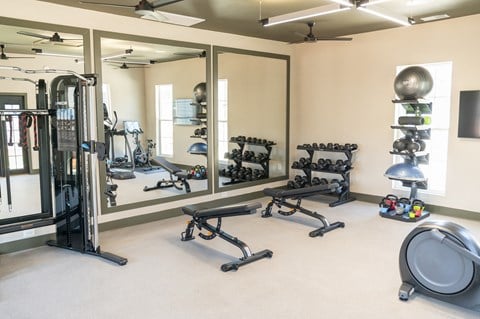 a fitness center with weights and other exercise equipment at Landon Green Artisan Cottages Apartments, Hickory