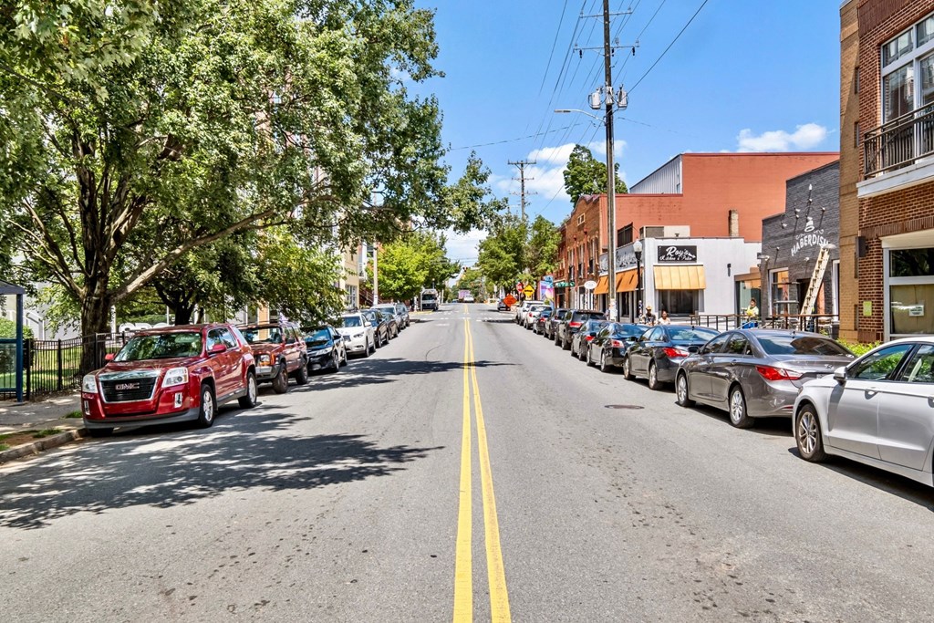 a city street with cars parked on the side of the road at The Collection Charlotte in Charlotte, NC, 28205