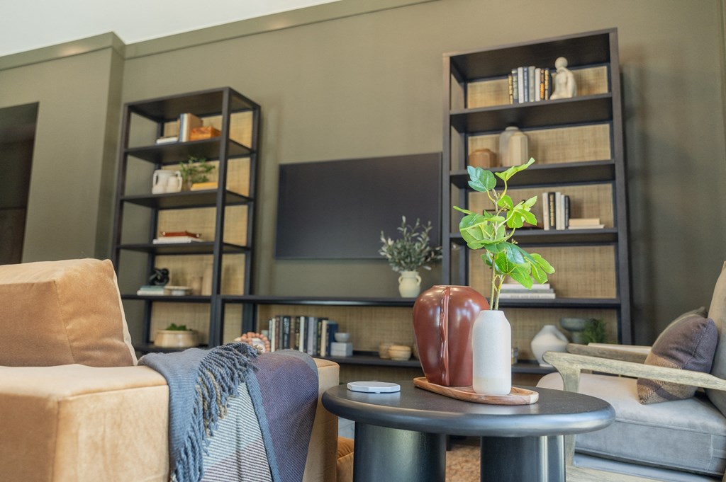 a living room with couches and a table with a vase on it at Landon Green Artisan Cottages Apartments, Hickory, NC