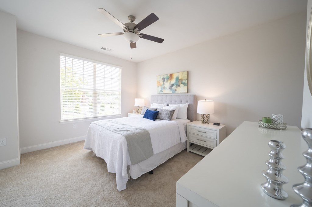 a bedroom with a bed and a ceiling fan at Landon Green Artisan Cottages Apartments, Hickory, NC