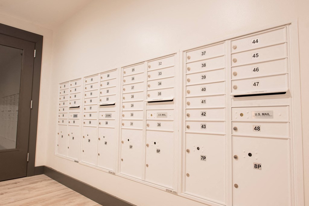 a wall of lockers in a room with a door