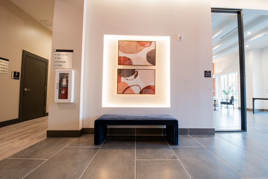 a painting on a wall with a bench in a lobby