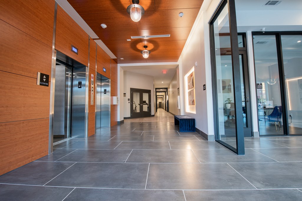 a hallway with glass doors and a ceiling fan