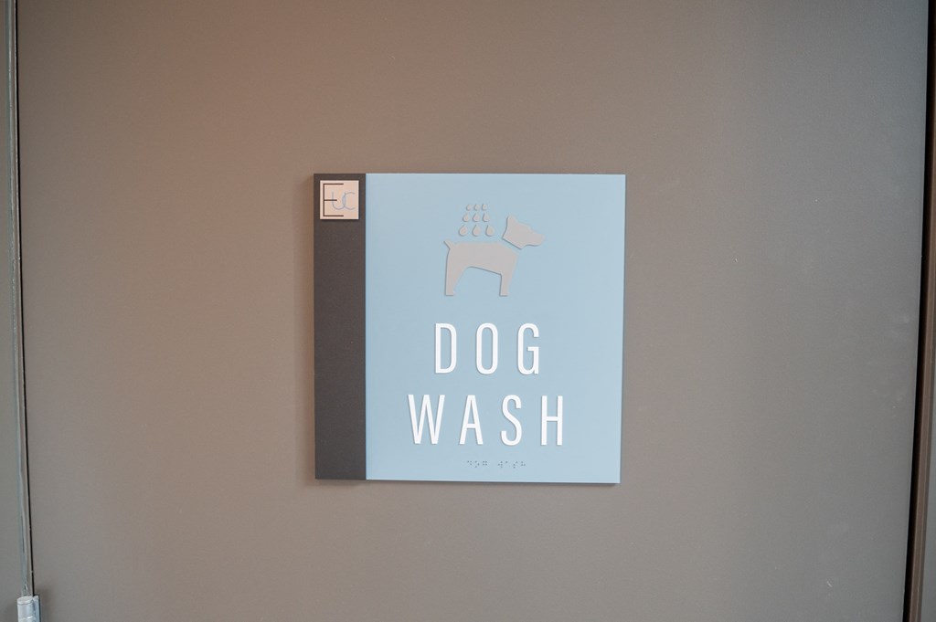 a sign for a dog wash on a wall