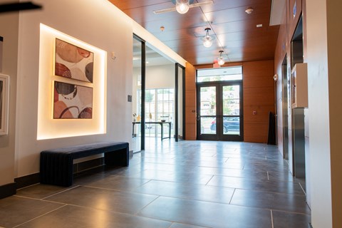 a hallway with a painting on the wall and glass doors