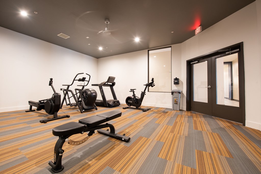 a gym with treadmills and exercise bikes in it