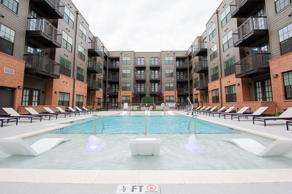 a swimming pool in front of an apartment building