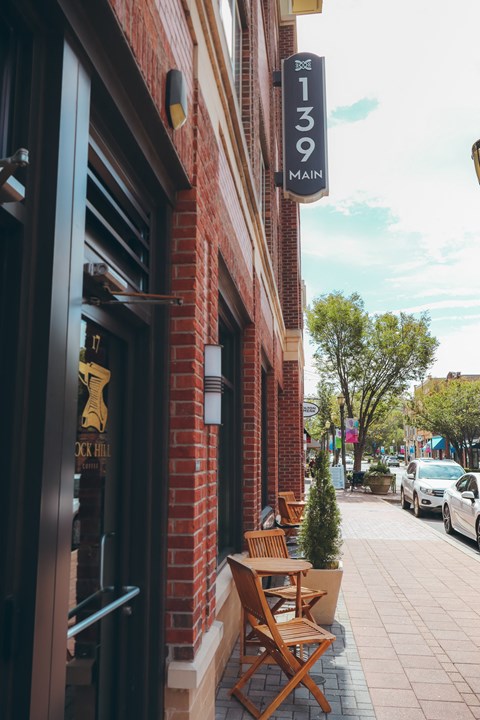 the outside of a restaurant with tables and chairs on the sidewalk