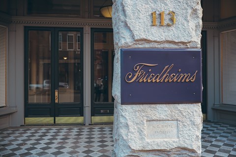 a sign on a wall outside of a building with doors