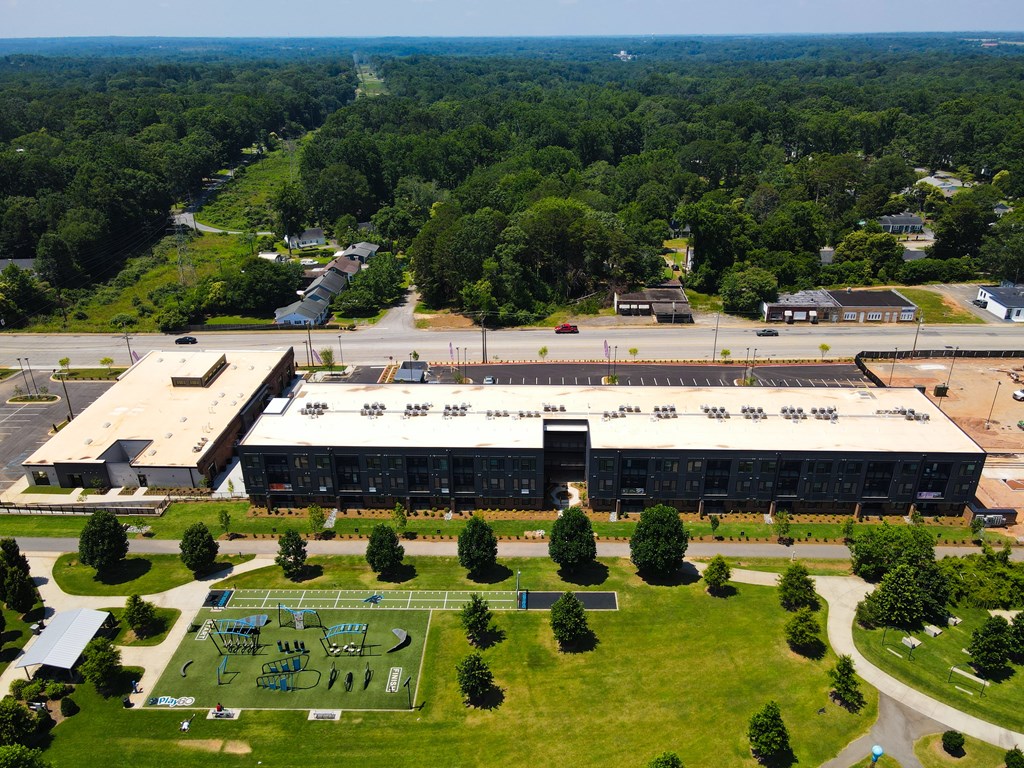 A large building with a green lawn in front of it.