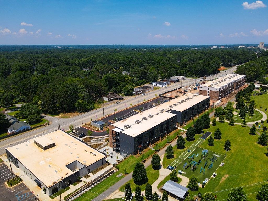 A large building complex with a parking lot in front.