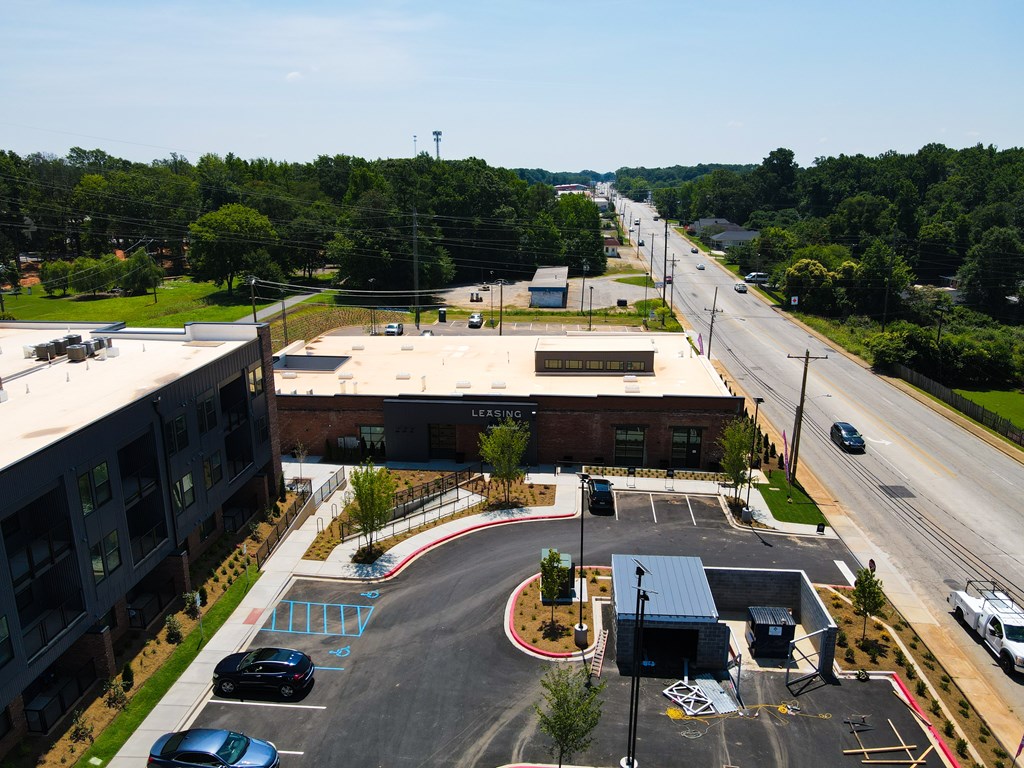 A parking lot with cars and a building with the word "LEARNING" on it.
