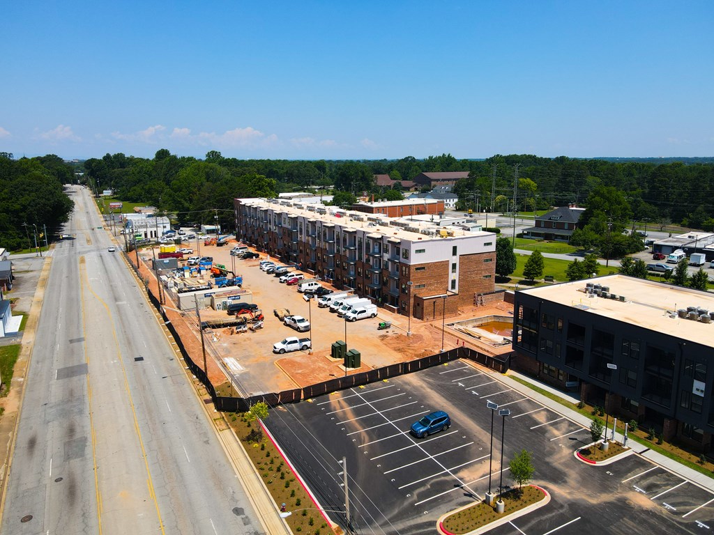 A parking lot is located in front of a large building.