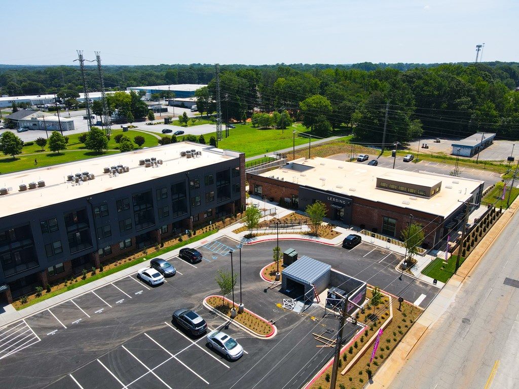A parking lot with cars and a building in the background.