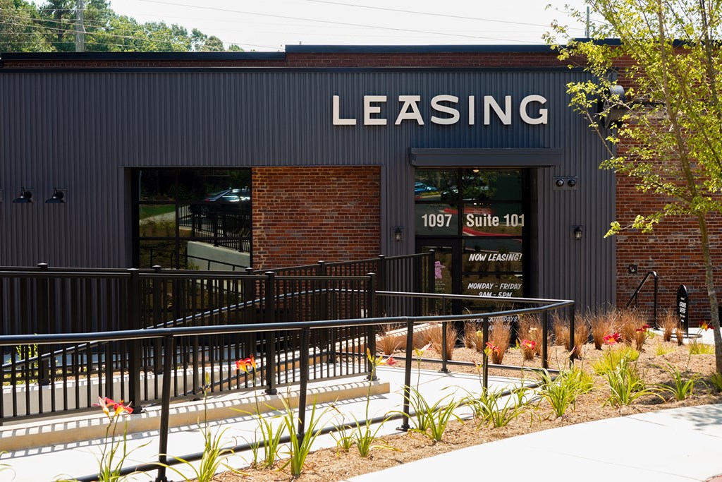A building with a sign that says "LEASING" on it.