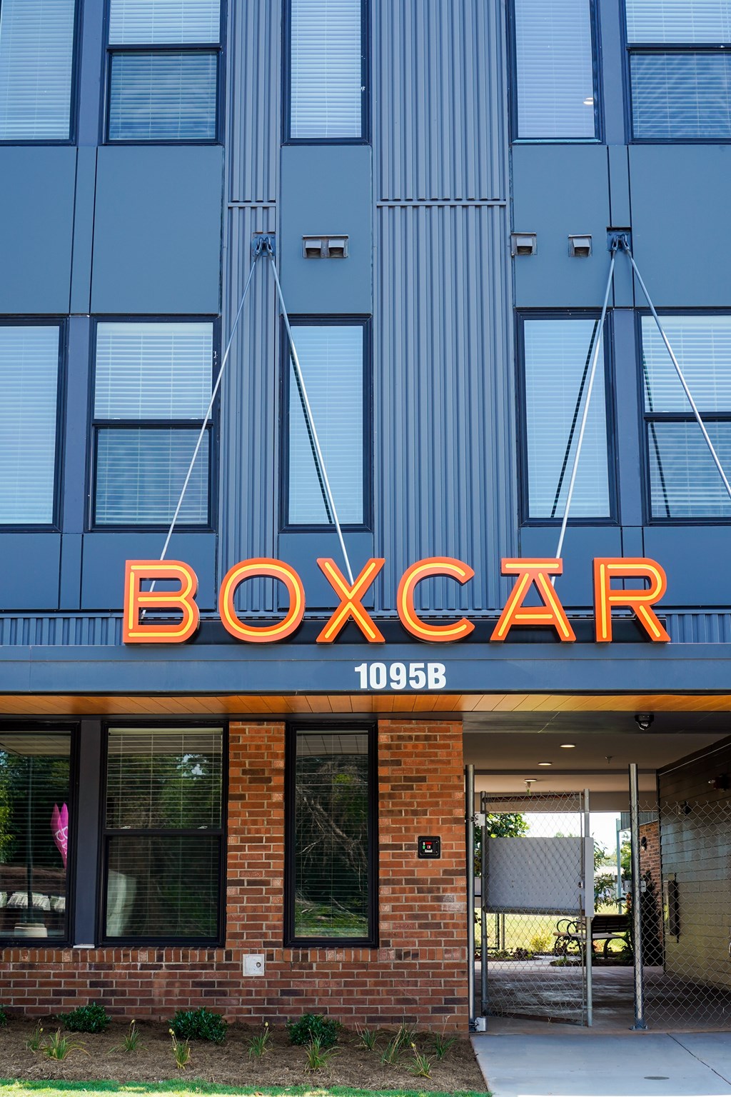 Boxcar building with orange letters on the front.