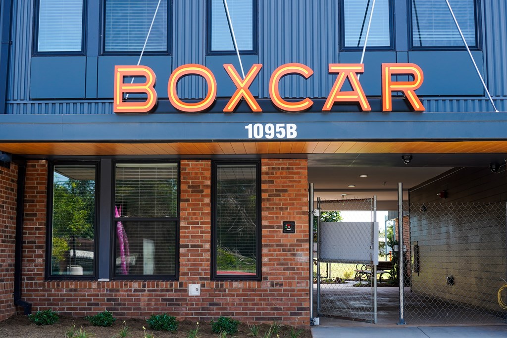 The front of a building with a neon sign that says BOXCAR.