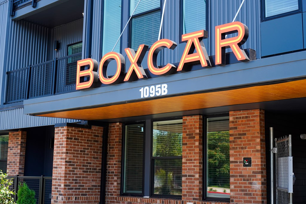 A neon sign that says BOXCAR in orange letters.