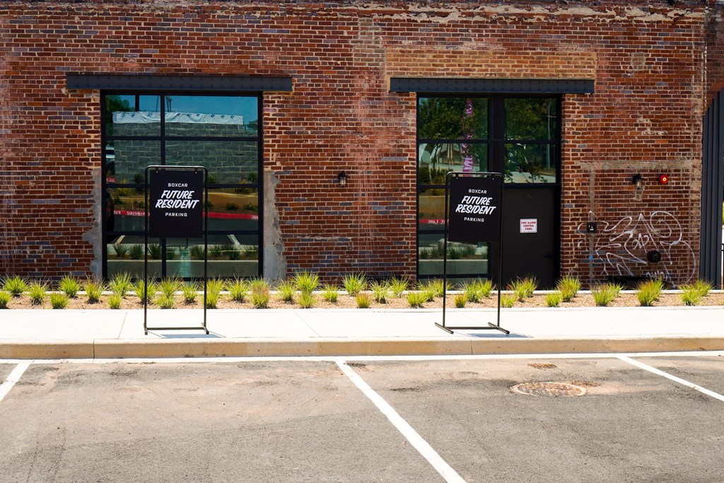 A brick building with two windows and a door.