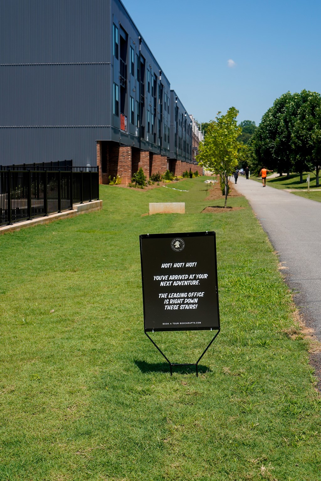 A sign in front of a building that says "You are not lost, you have arrived at your next adventure."