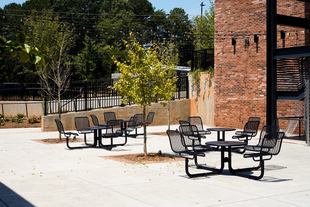 A black metal table and chairs are set up on a patio.