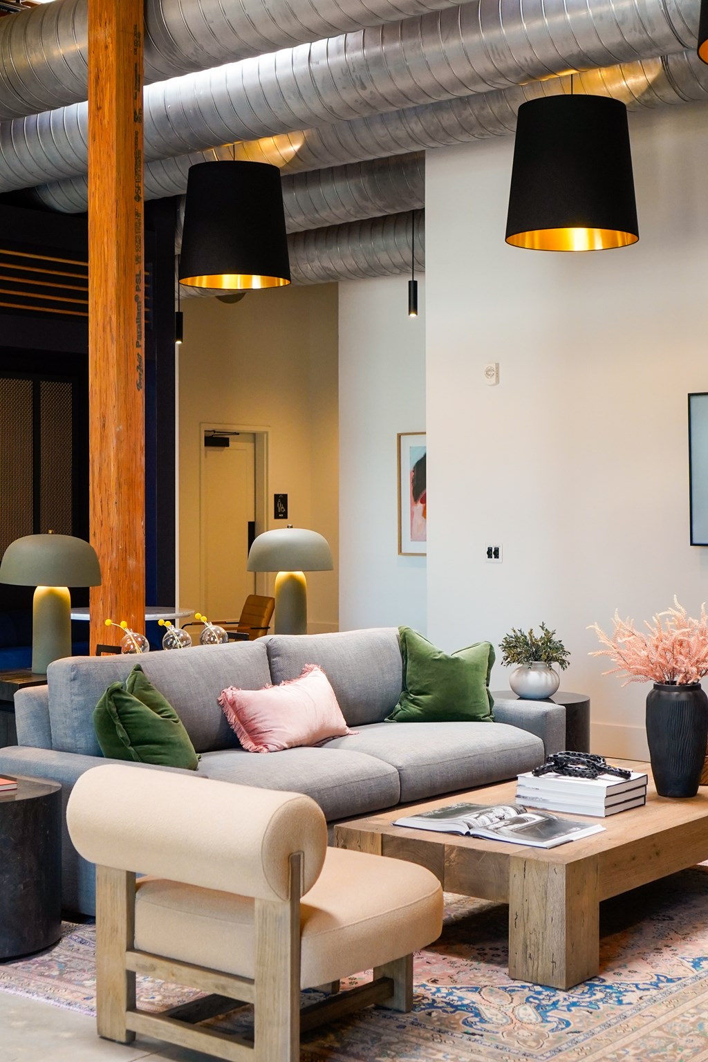 A living room with a grey couch and a wooden coffee table.