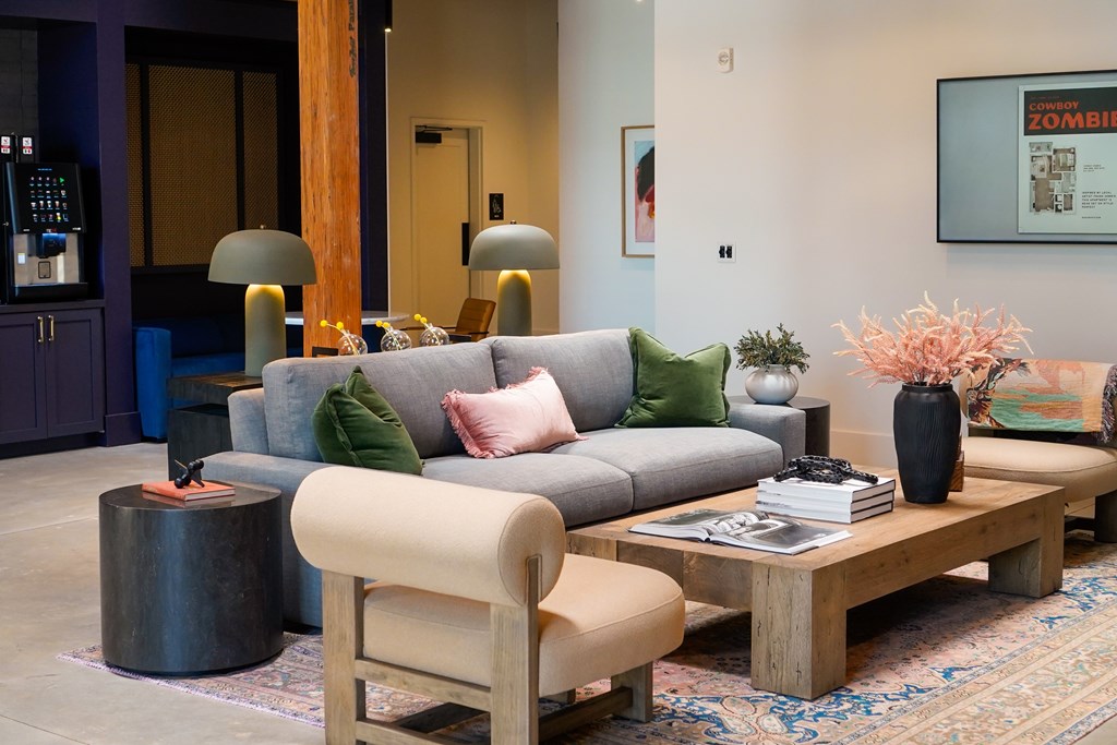 A living room with a grey couch and a wooden coffee table.