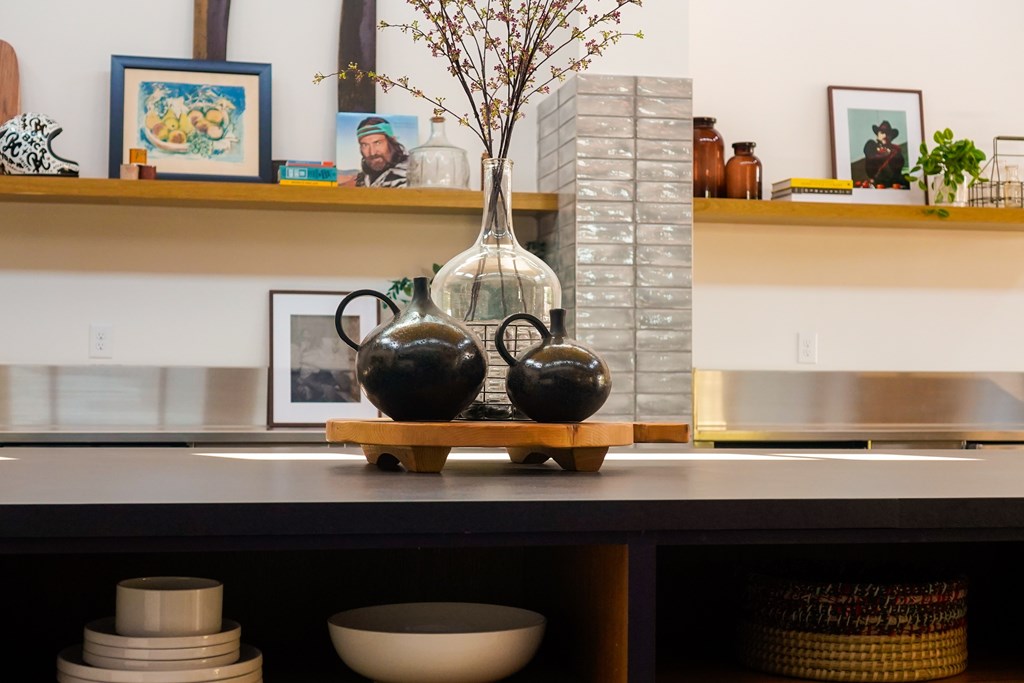 A shelf with various decorative items including vases and bowls.