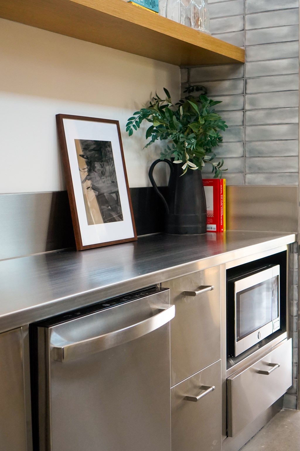 A modern kitchen with a stainless steel dishwasher and oven.