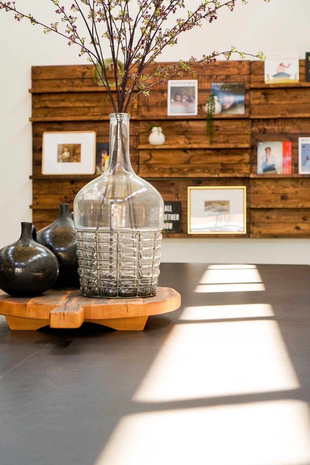 A vase with a plant in it is on a table.