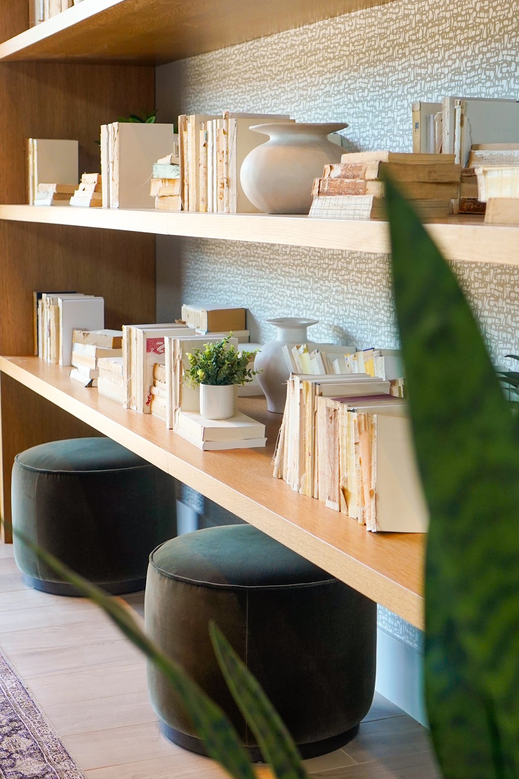 A shelf with books, vases and other items.