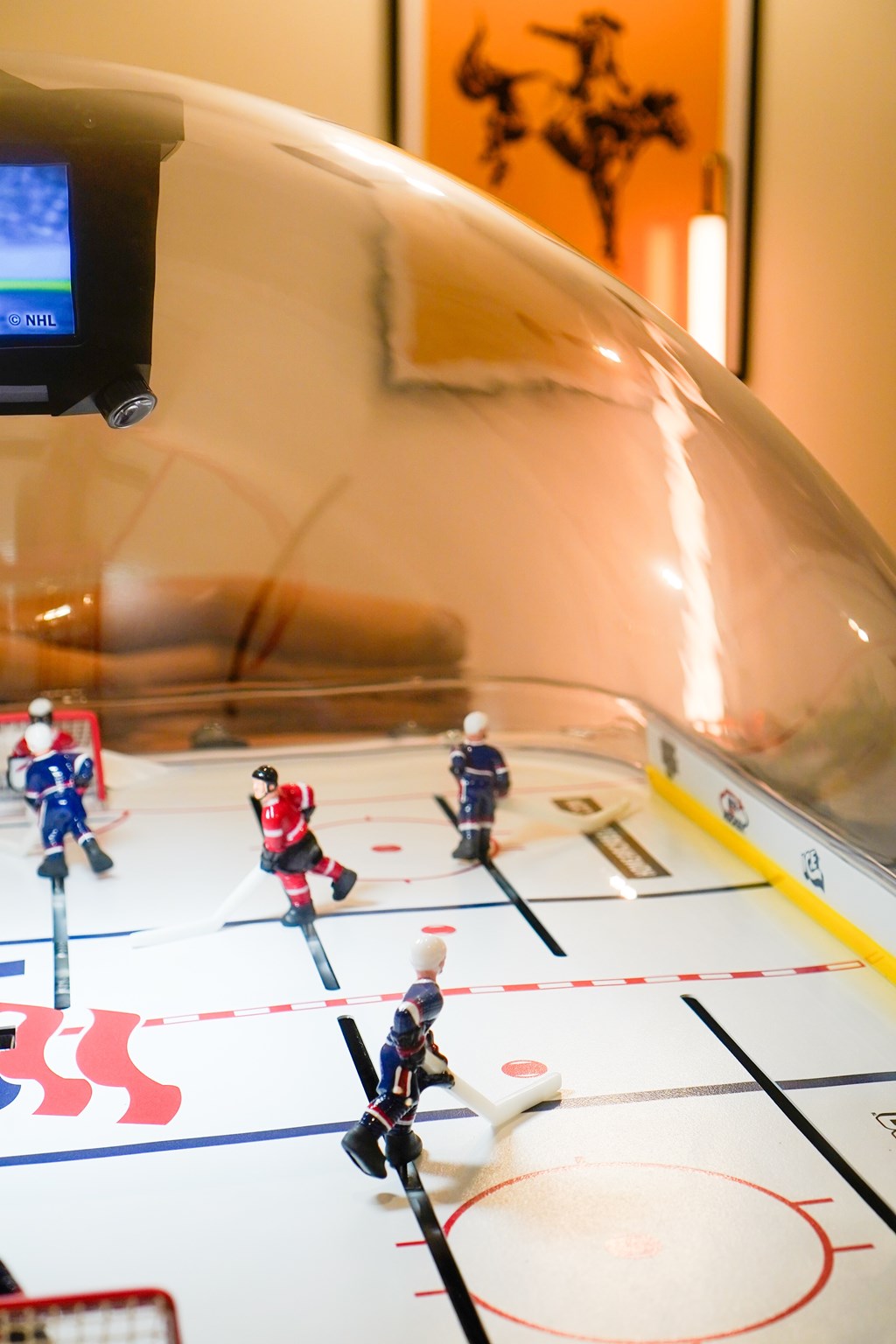 A small hockey game is set up on a table.