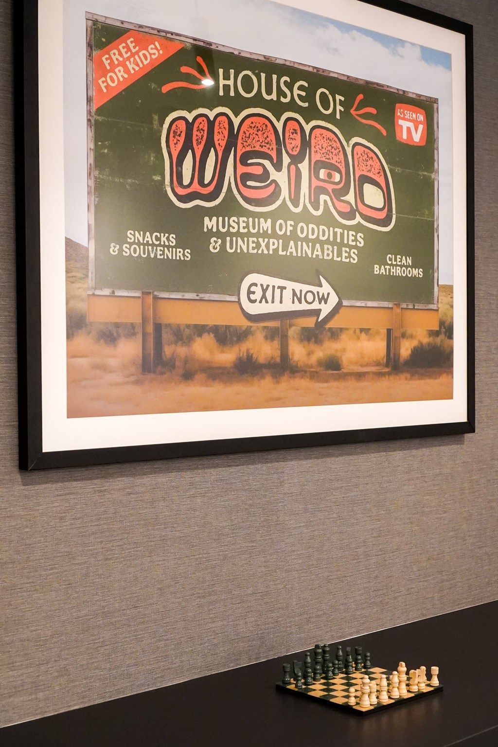 A framed poster advertising the House of Weird Museum.