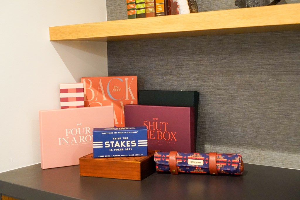 A collection of books and boxes on a shelf.