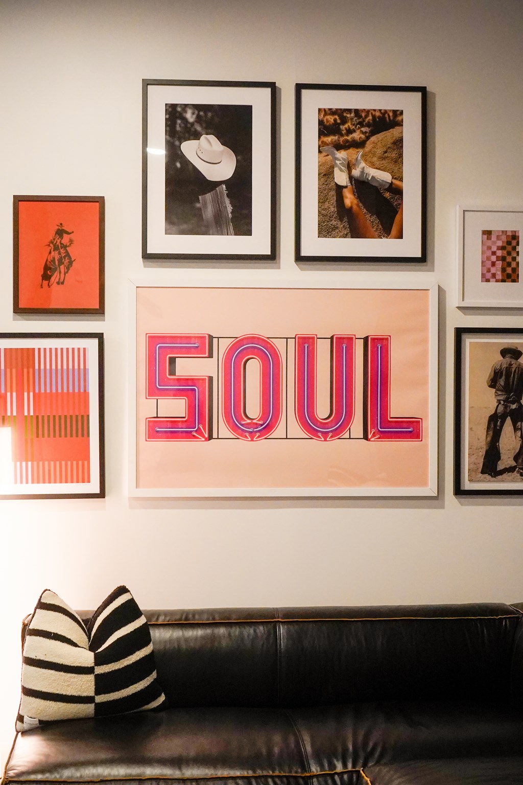 A living room with a couch and pictures on the wall.