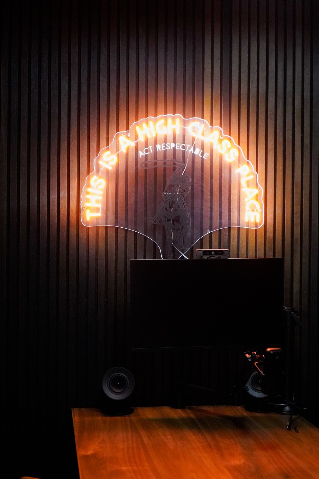 A neon sign that says "This is a whole other respeckacle place".