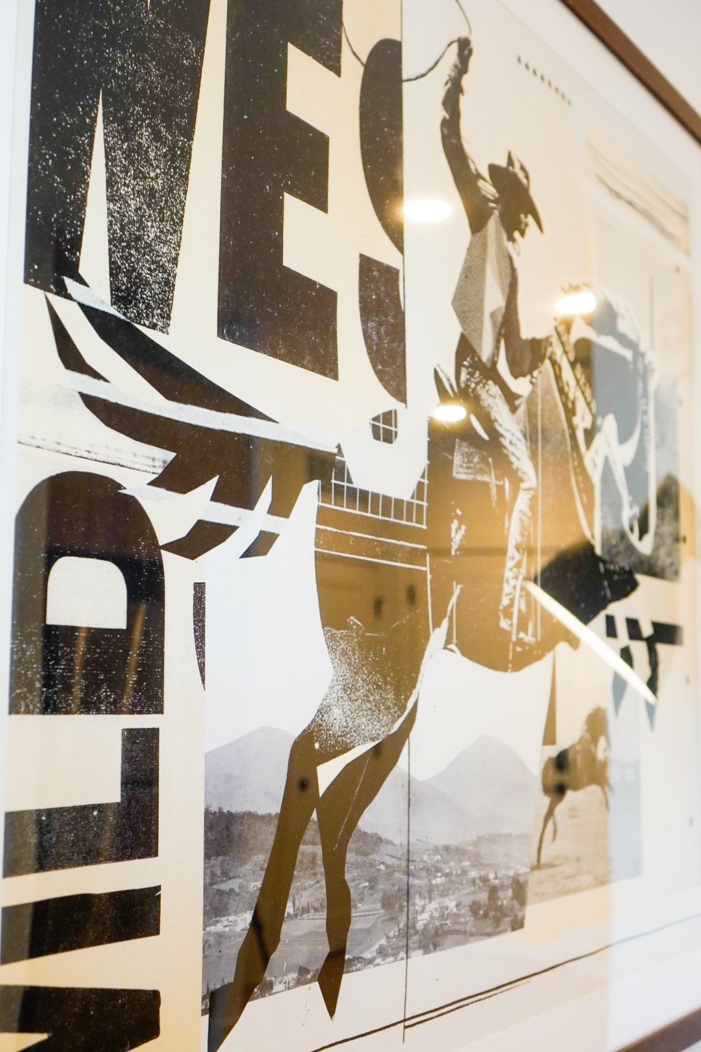 A poster with a cowboy riding a bucking horse.