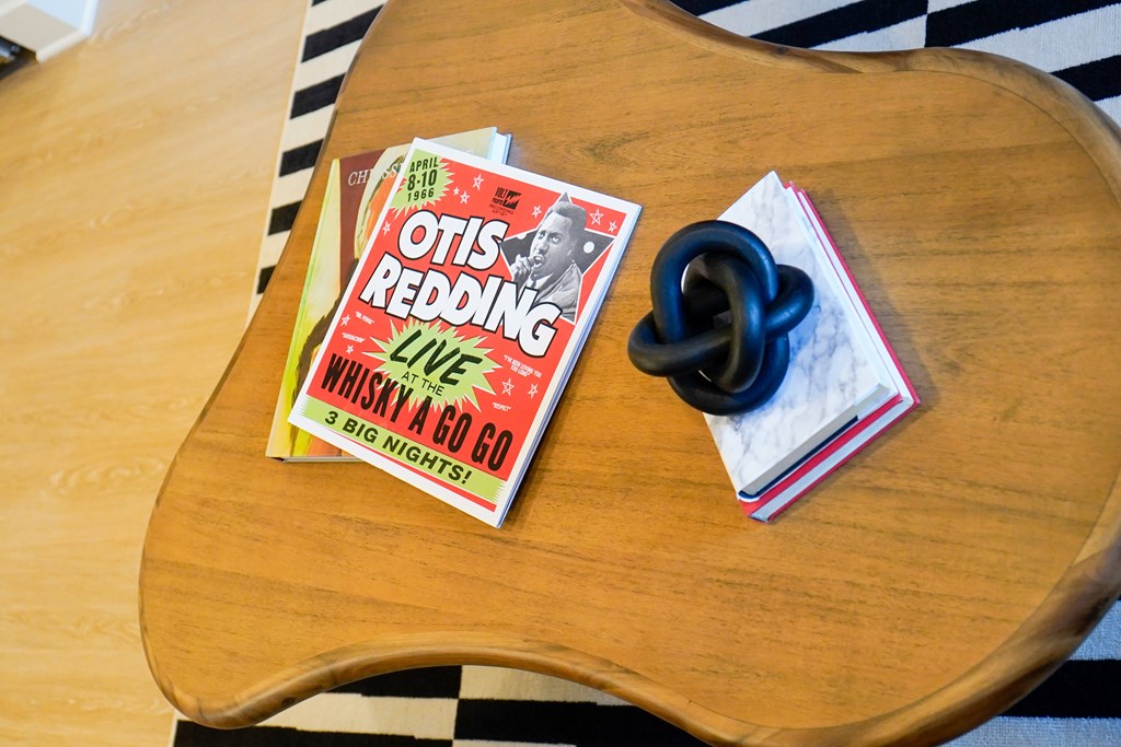 A book titled Otis Redding Live is on a wooden table.