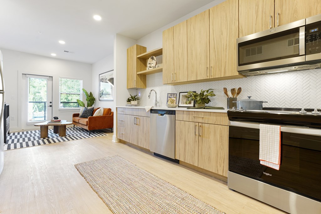 A modern kitchen with wooden cabinets and stainless steel appliances.