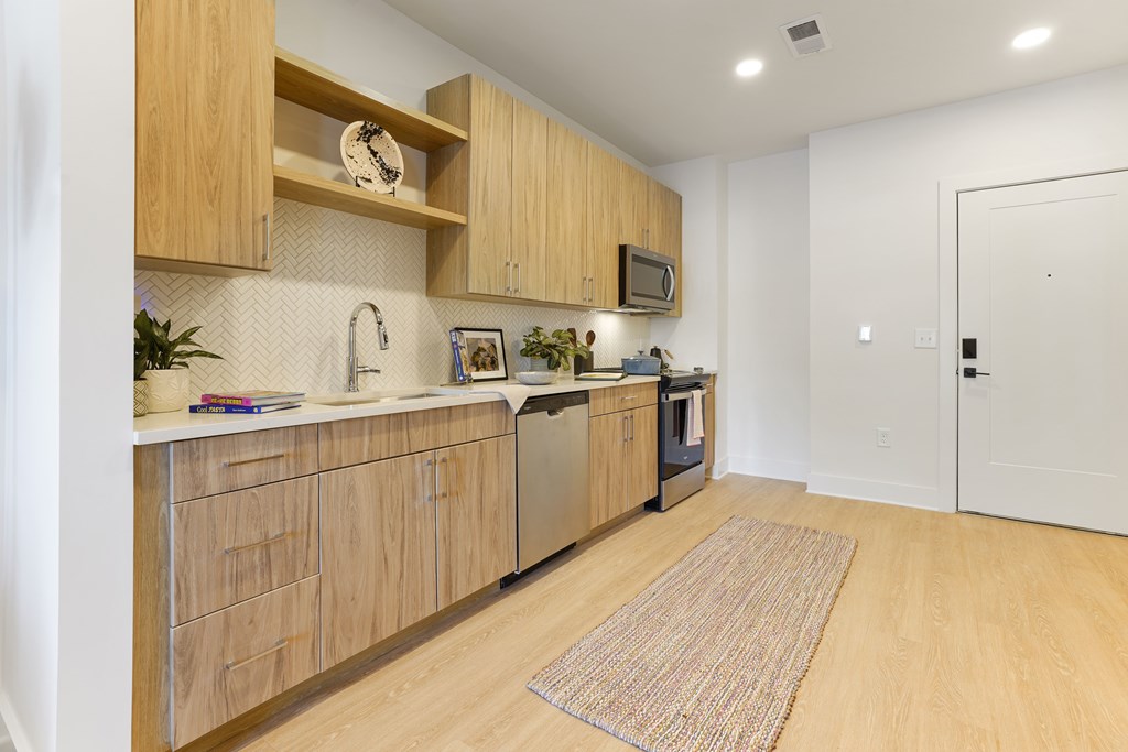 A kitchen with wooden cabinets and a white countertop.