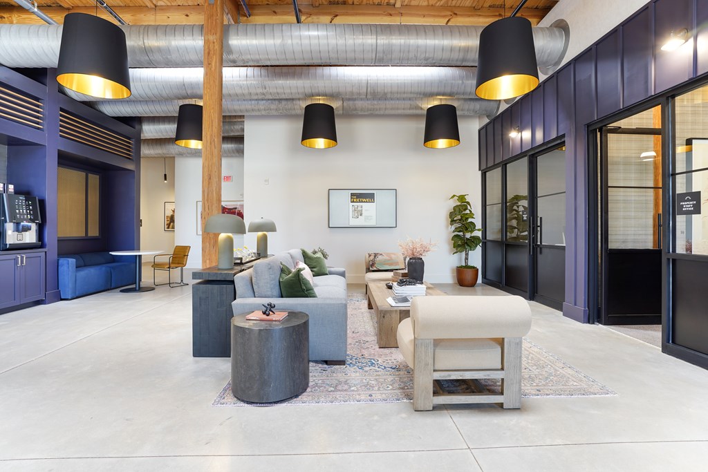 A modern living room with a grey sofa and a wooden coffee table.