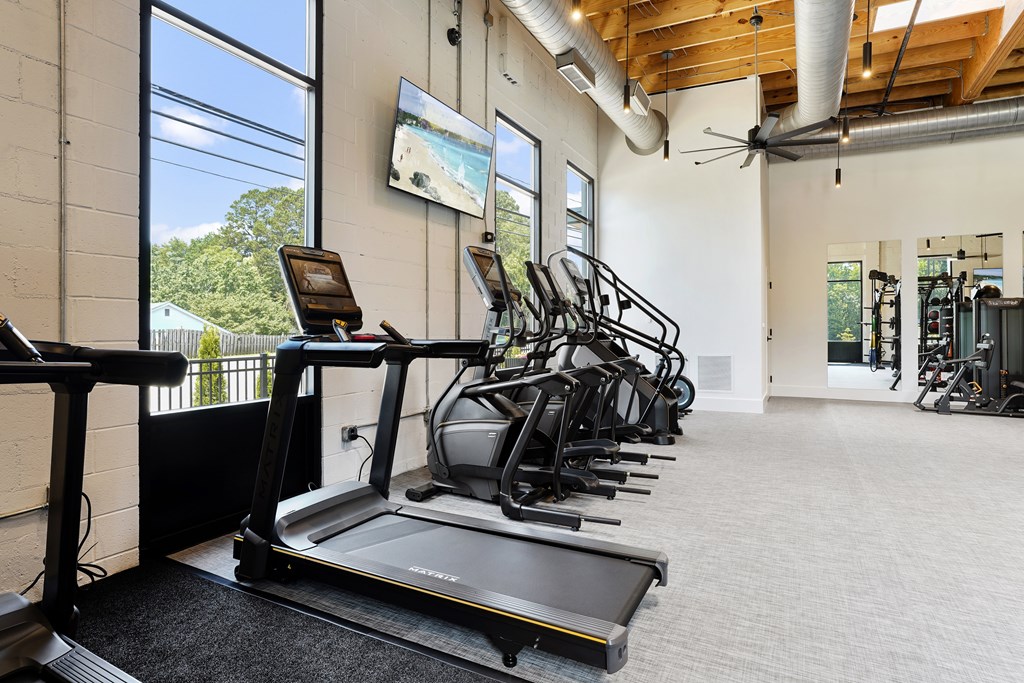A gym with treadmills and exercise equipment.